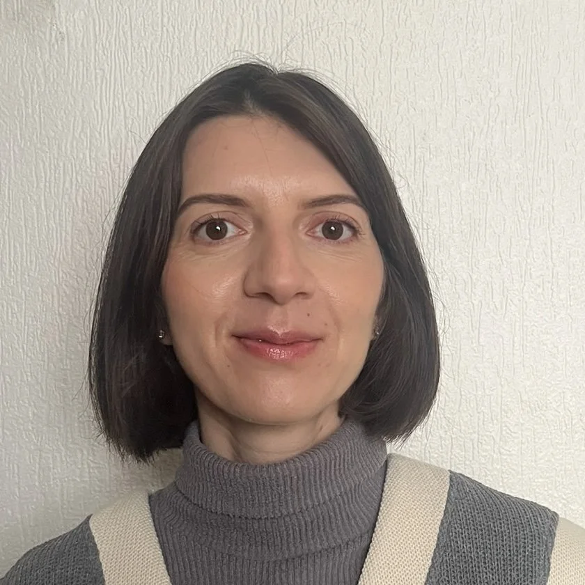 Headshot of Lena Shyryna. She wears a grey turtleneck.