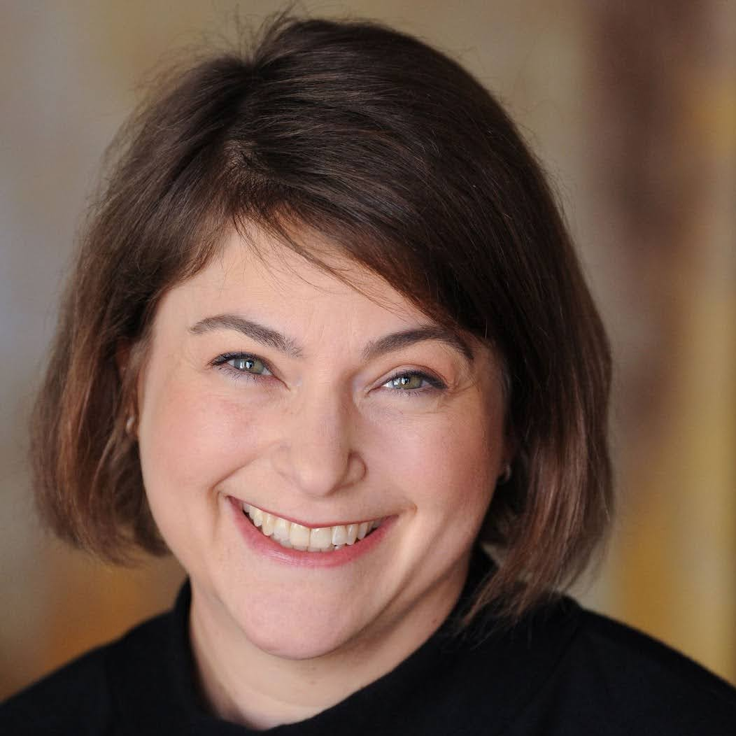 Headshot of Margo Stern, a white woman with a light brown bob and wearing a black top.