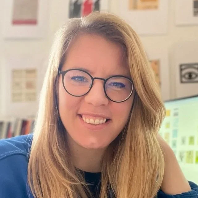 Headshot of Ida Persson, a blond woman wearing glasses and a blue shirt.
