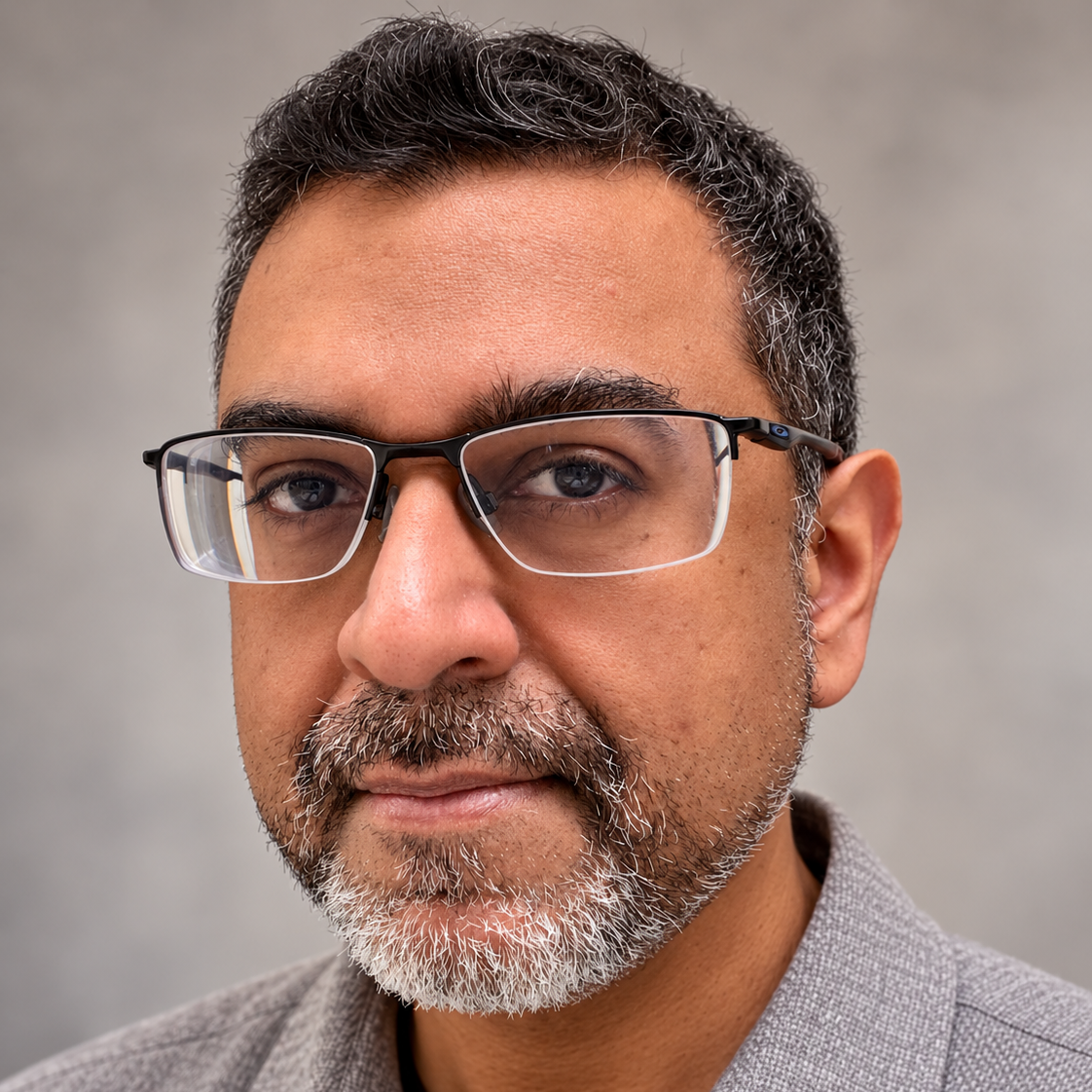 Headshot of Uday Gajendar. He wears glasses and a goatee.