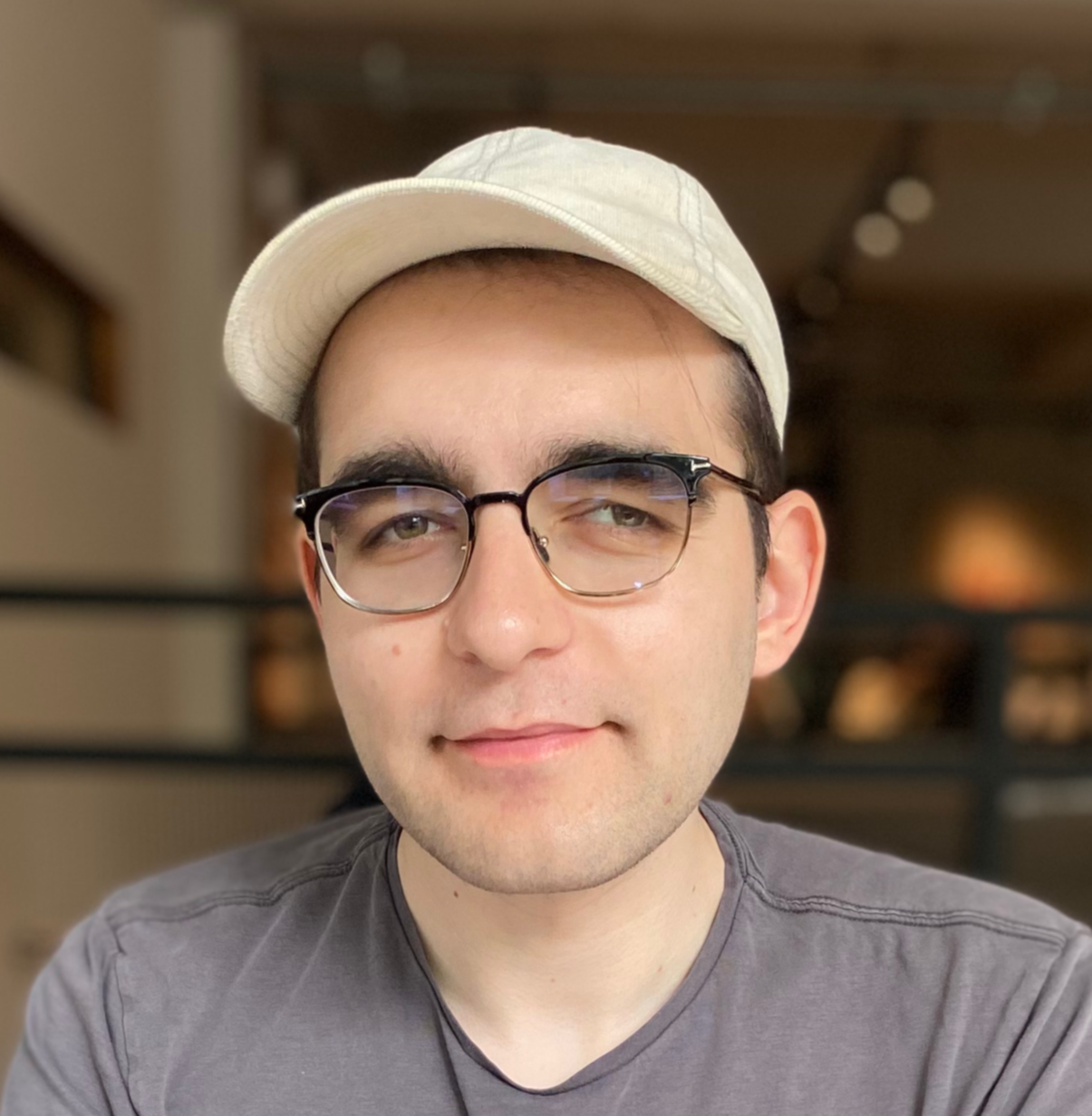 Headshot of Pavel Samsonov, a white man in a ballcap and glasses.