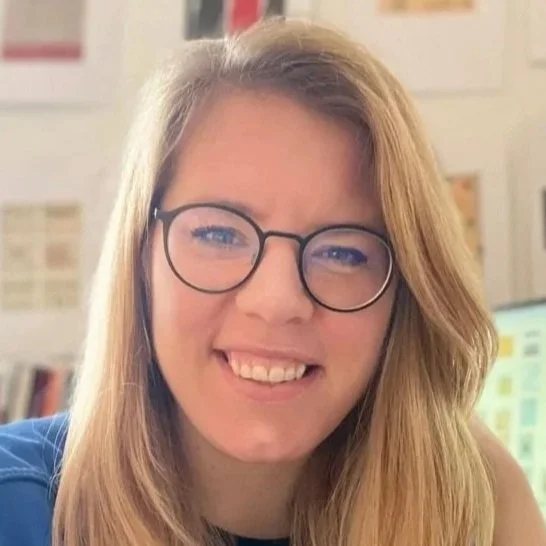 Ida Persson, a white woman with blond hair and glasses smiling.