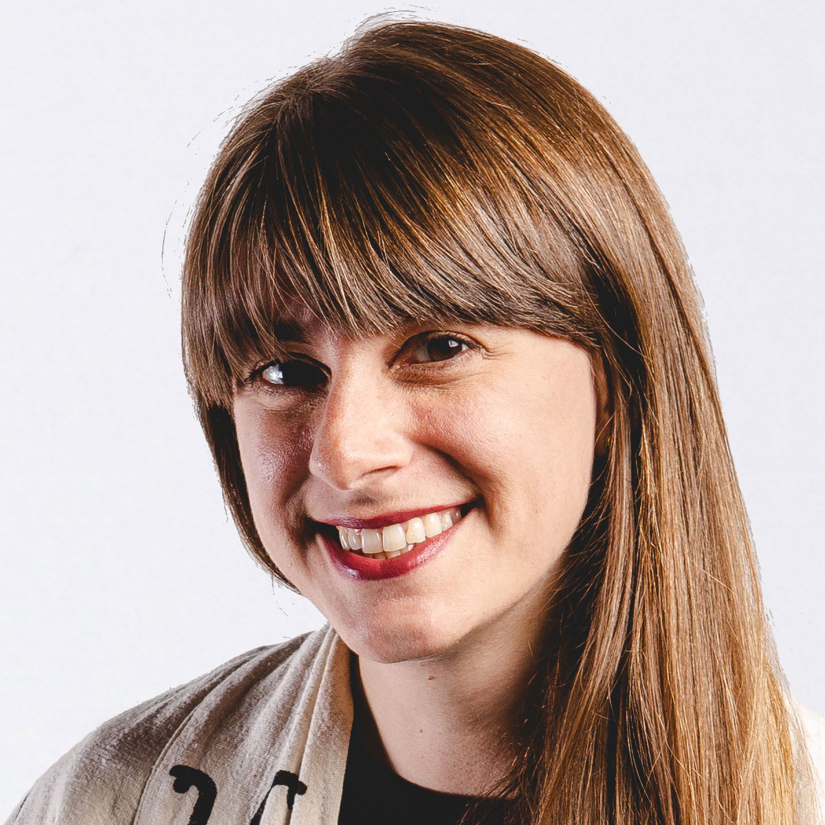 Headshot of Krissi Xenakis. She has long brown hair and bangs.