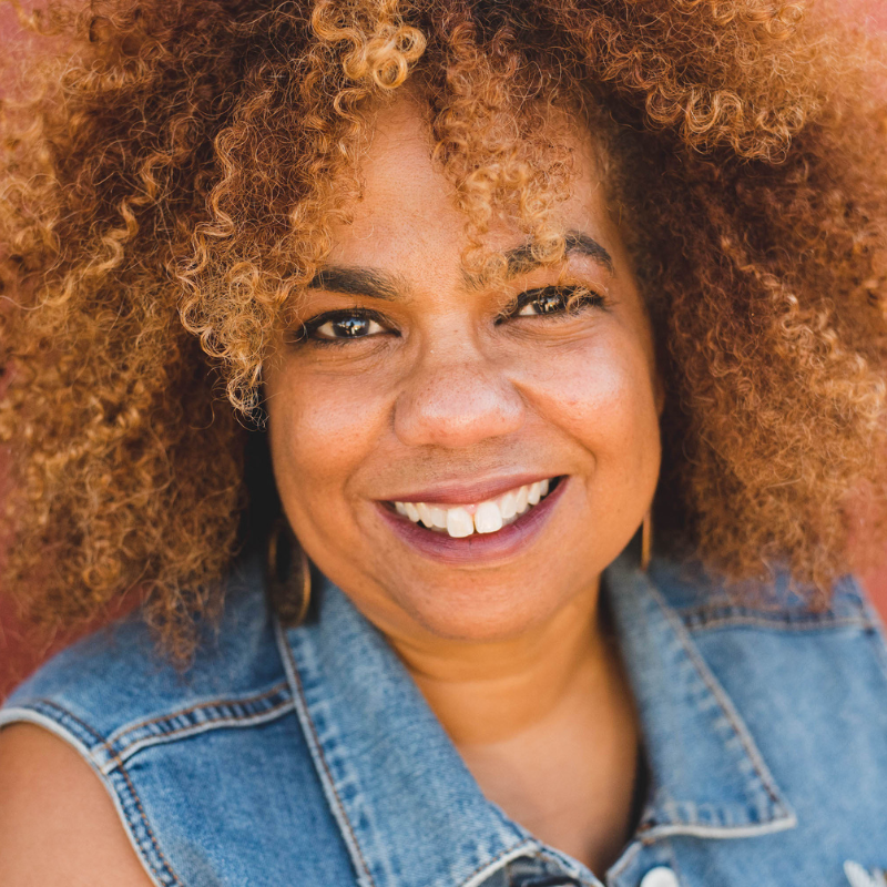 Headshot of Natalie Dunbar, a Black woman with an afro wearing a denim top.