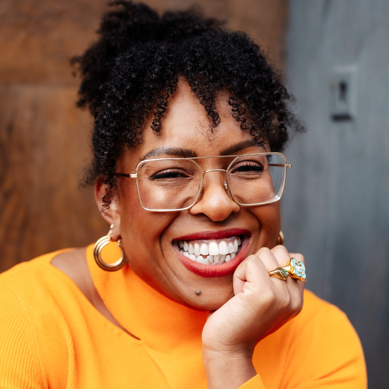 Headshot of Venessa Bennett, a Black woman wearing glasses and a yellow top.