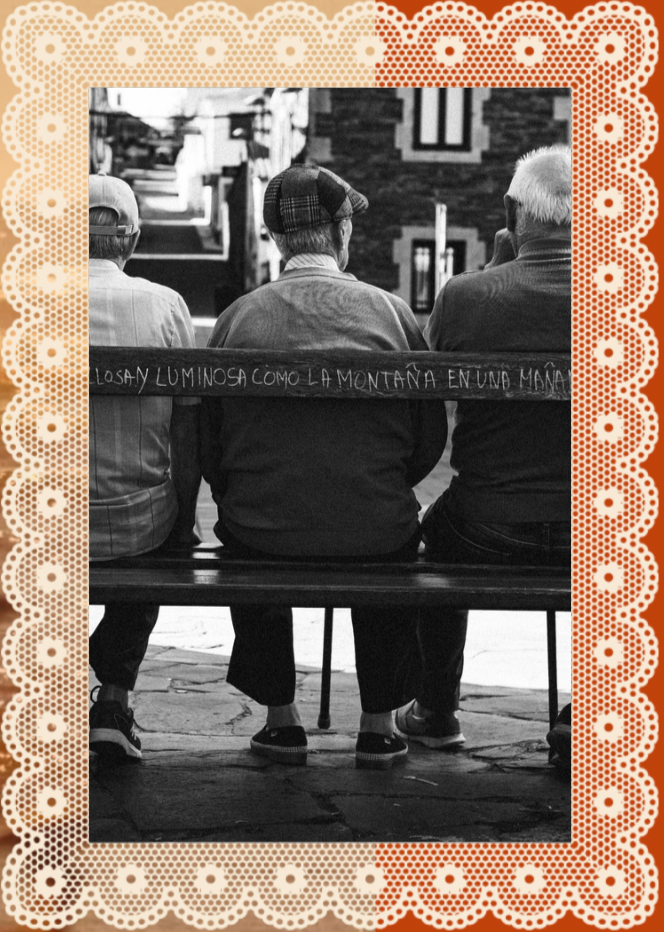 Three elderly men sitting on a park bench in an urban setting, viewed from behind. The middle man wears a plaid cap, and there is a quote written on a board or sign in front of them.
