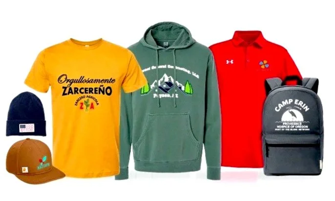 Collection of outdoor and casual clothing items, including a navy blue beanie, a brown cap, a yellow T-shirt, a green hoodie, a red polo shirt, and a black backpack with 'Camp Erin' logo.