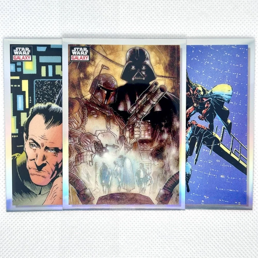 Three Star Wars comic books with colorful cover illustrations featuring characters from the Star Wars universe displayed upright on a white surface.