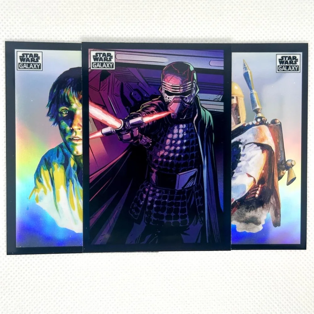 Three Star Wars posters featuring characters from the Star Wars galaxy. The middle poster shows a figure in black armor with a helmet, holding a red lightsaber. The left poster depicts a person with short dark hair with a holographic or rainbow-like effect, and the right poster shows a character with a helmet and armor holding a weapon.