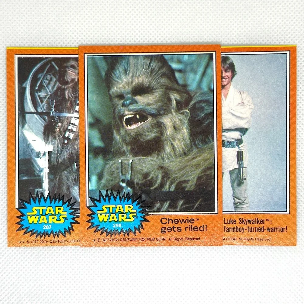 Star Wars trading cards featuring Chewie with the caption 'Chewie gets riled!' and Luke Skywalker with the caption 'Luke Skywalker: farmboy-turned-warrior!'