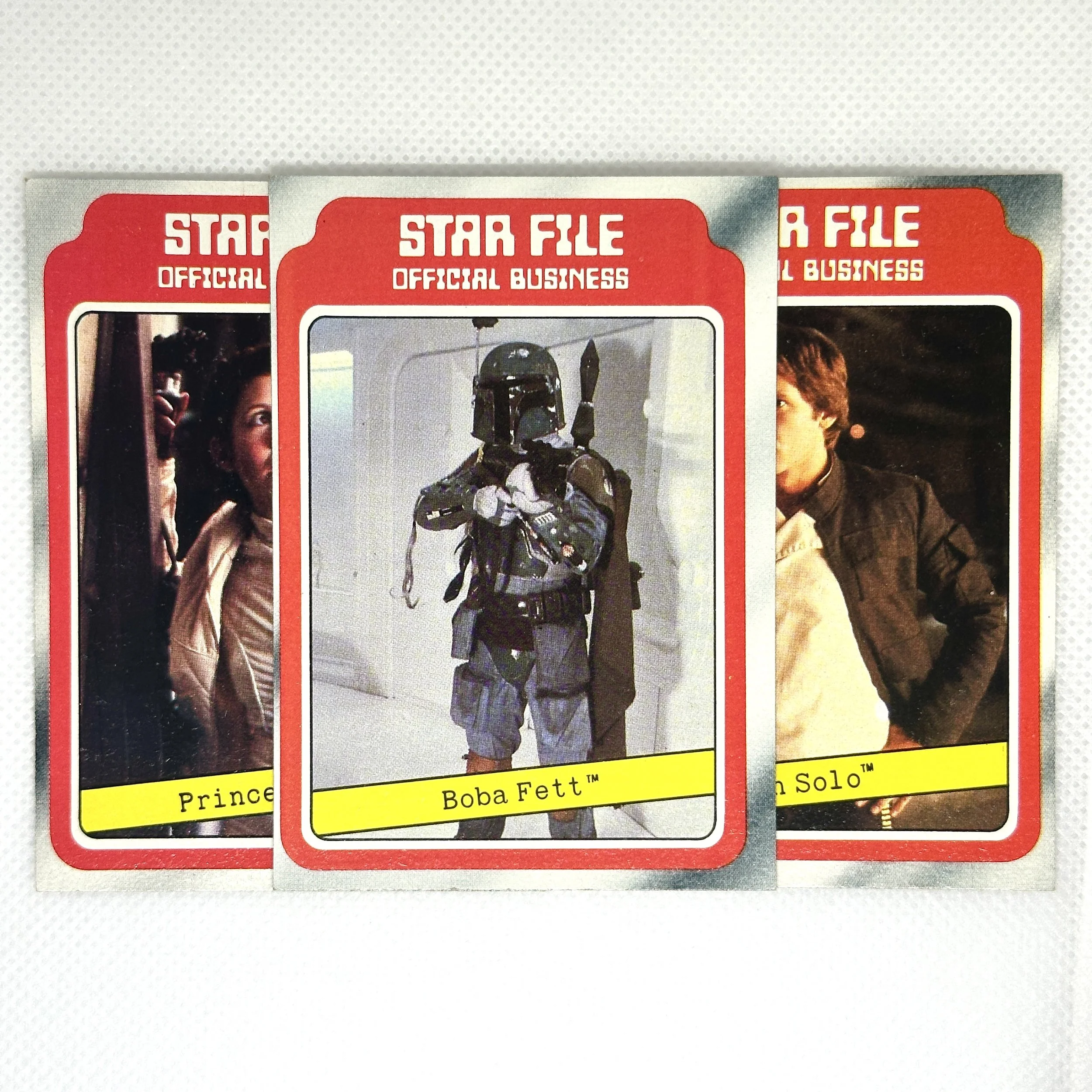 Three collectible Star Wars trading cards featuring characters Princess Leia, Boba Fett, and Han Solo.