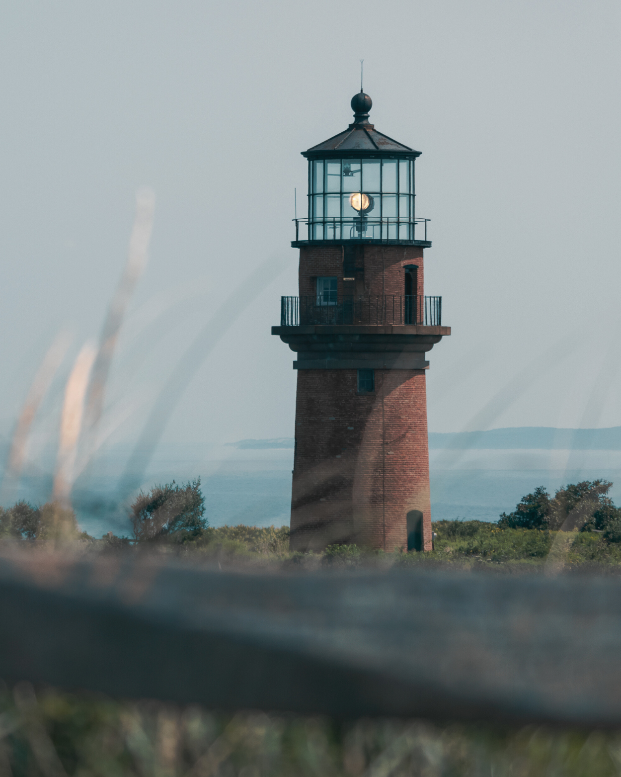 The historic red brick Gay Head Lighthouse overlooking the ocean on Martha’s Vineyard, symbolizing On Island Services’ steadfast property management and concierge care in Edgartown, MA.
