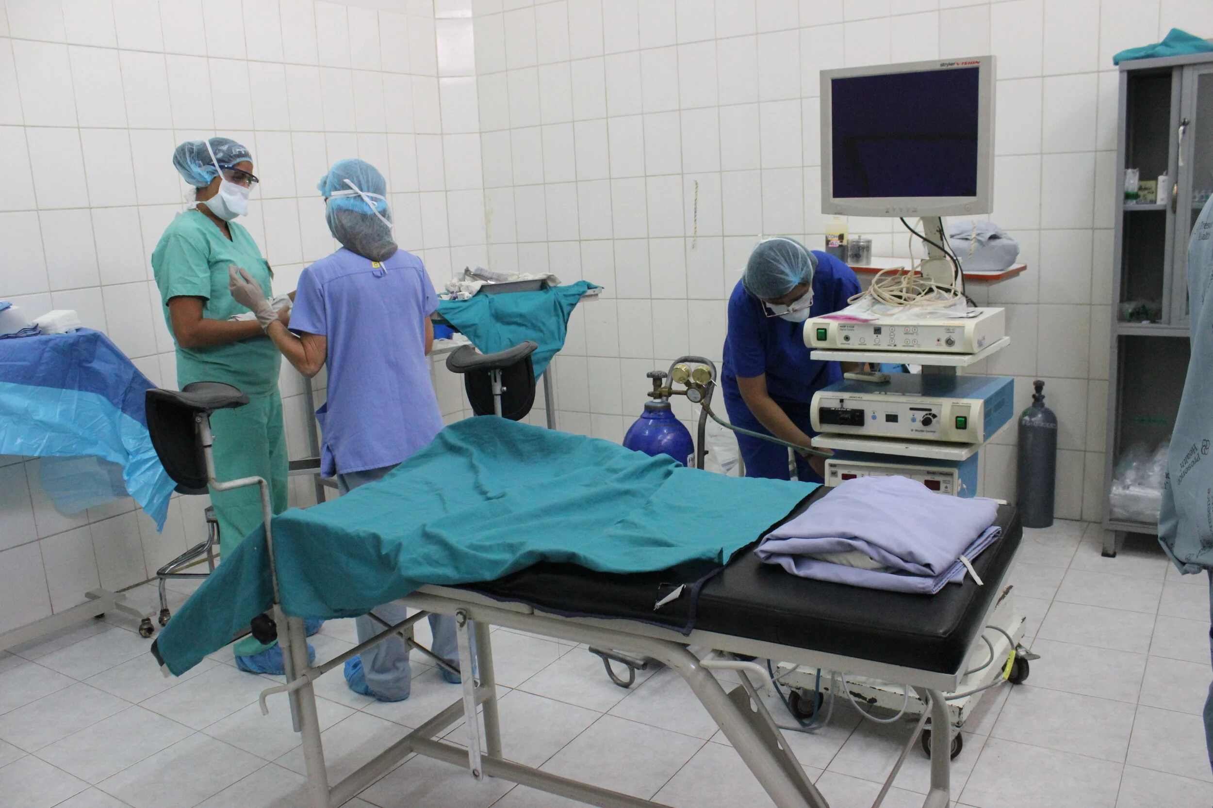  consulting with her fellow missioner, Surgical Nurse Jen, as they prepare the OR 