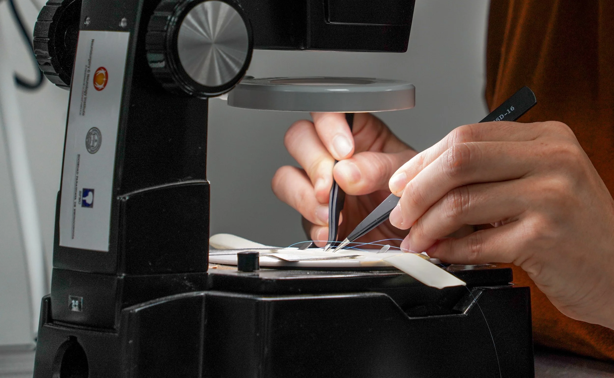 Image of of a surgeon's hands using medical supplies.