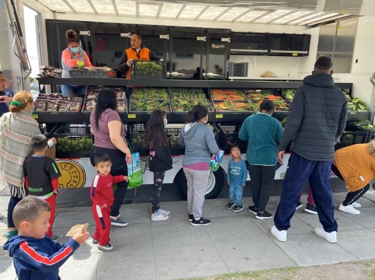 Community members in line at a mobile market truck
