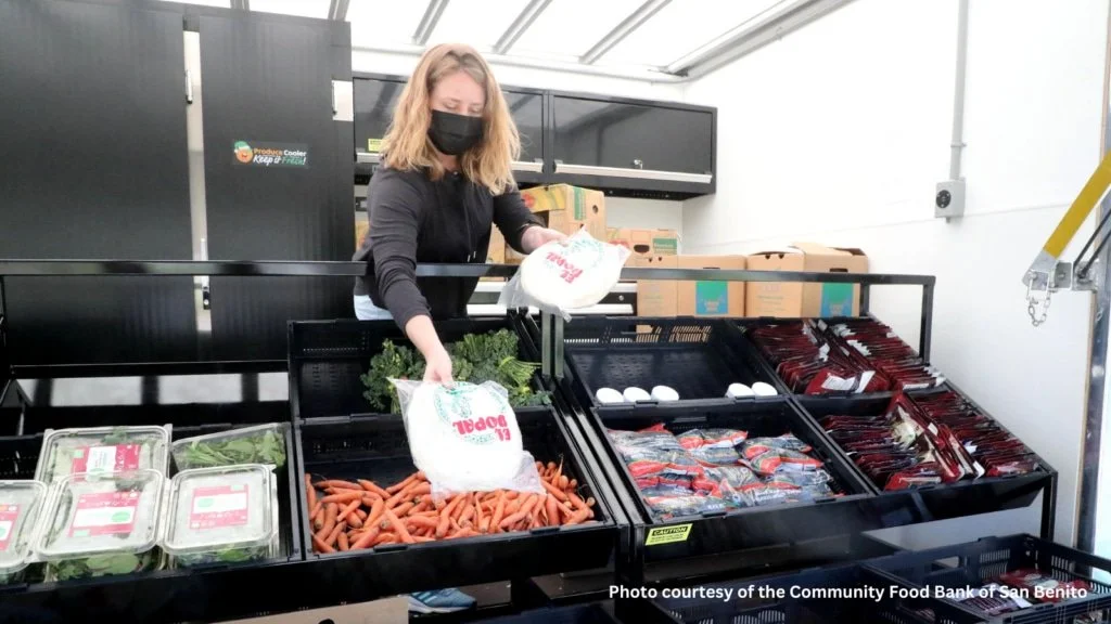 A volunteer wearing a mask works at a mobile market