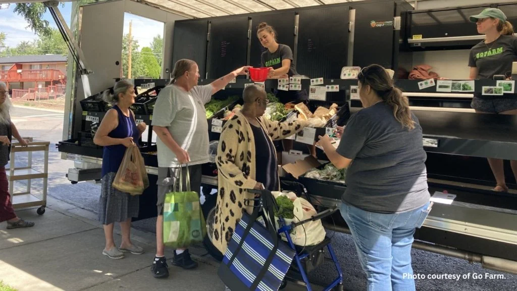 Community members getting produce from the GoFarm mobile market truck