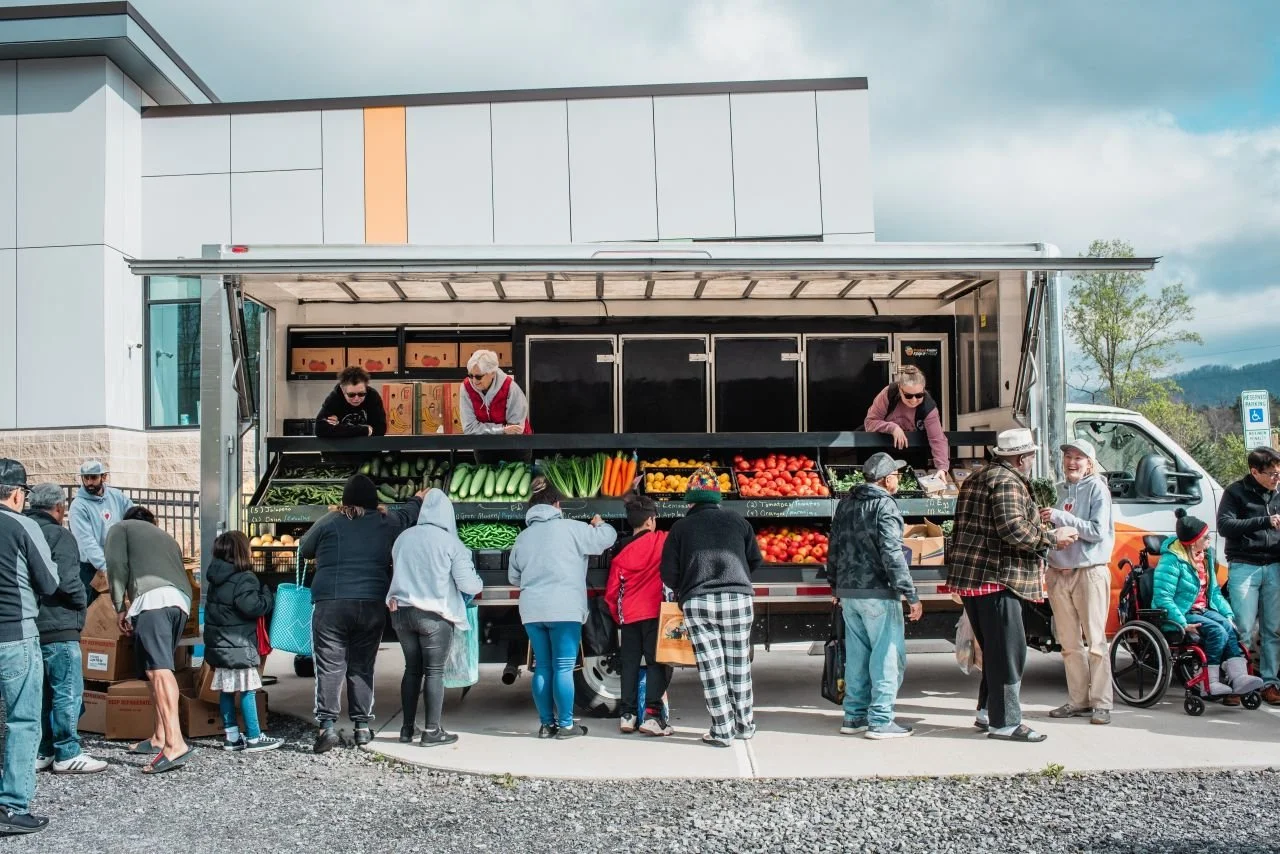 Shoppers line up at a Farmers' Truck mobile market run by Bounty & Soul in Black Mountain, North Carolina