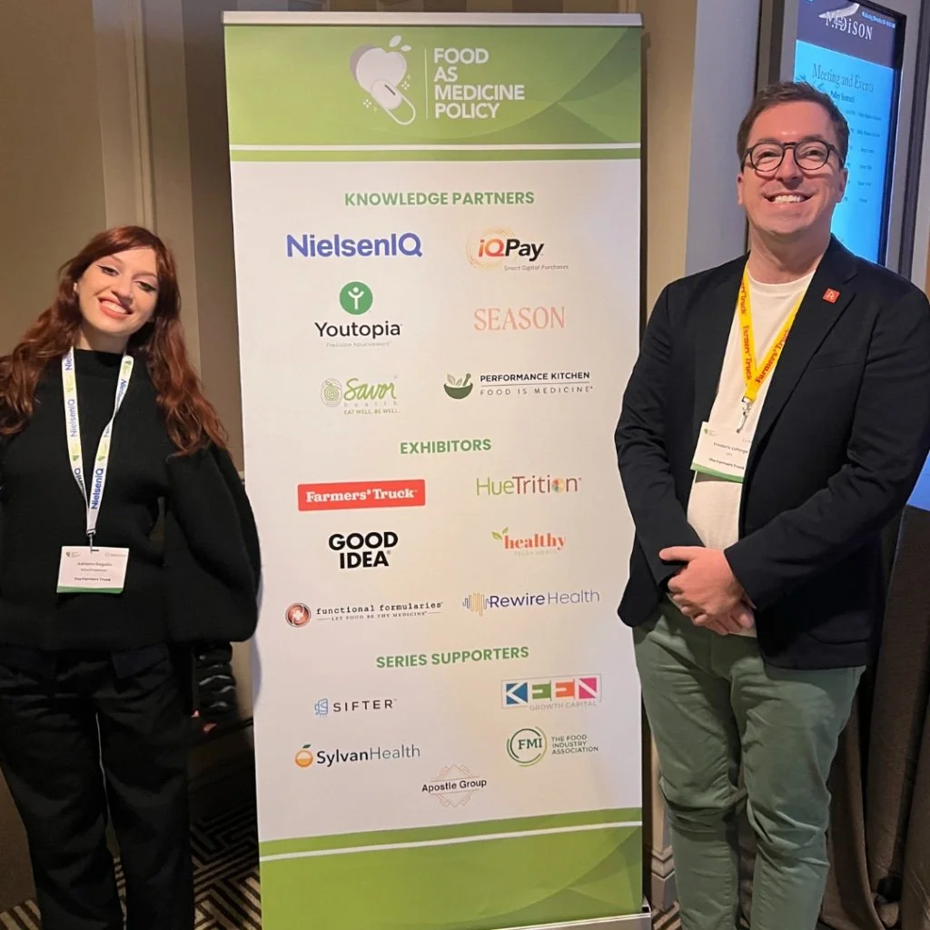 Fred standing in front of a banner at a food as medicine policy event