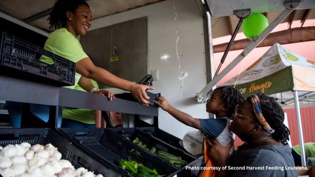 A worker assists customers at a mobile market