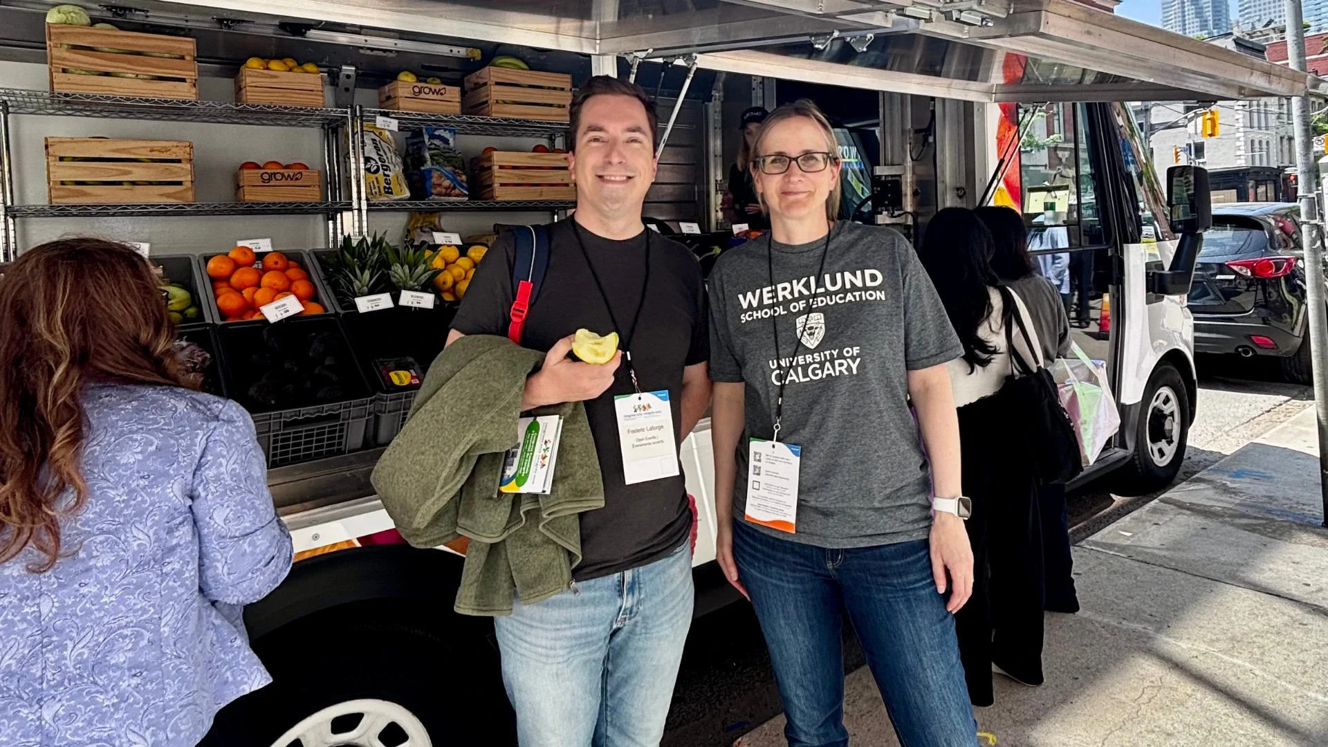 Fred and colleague stand in front of mobile market truck