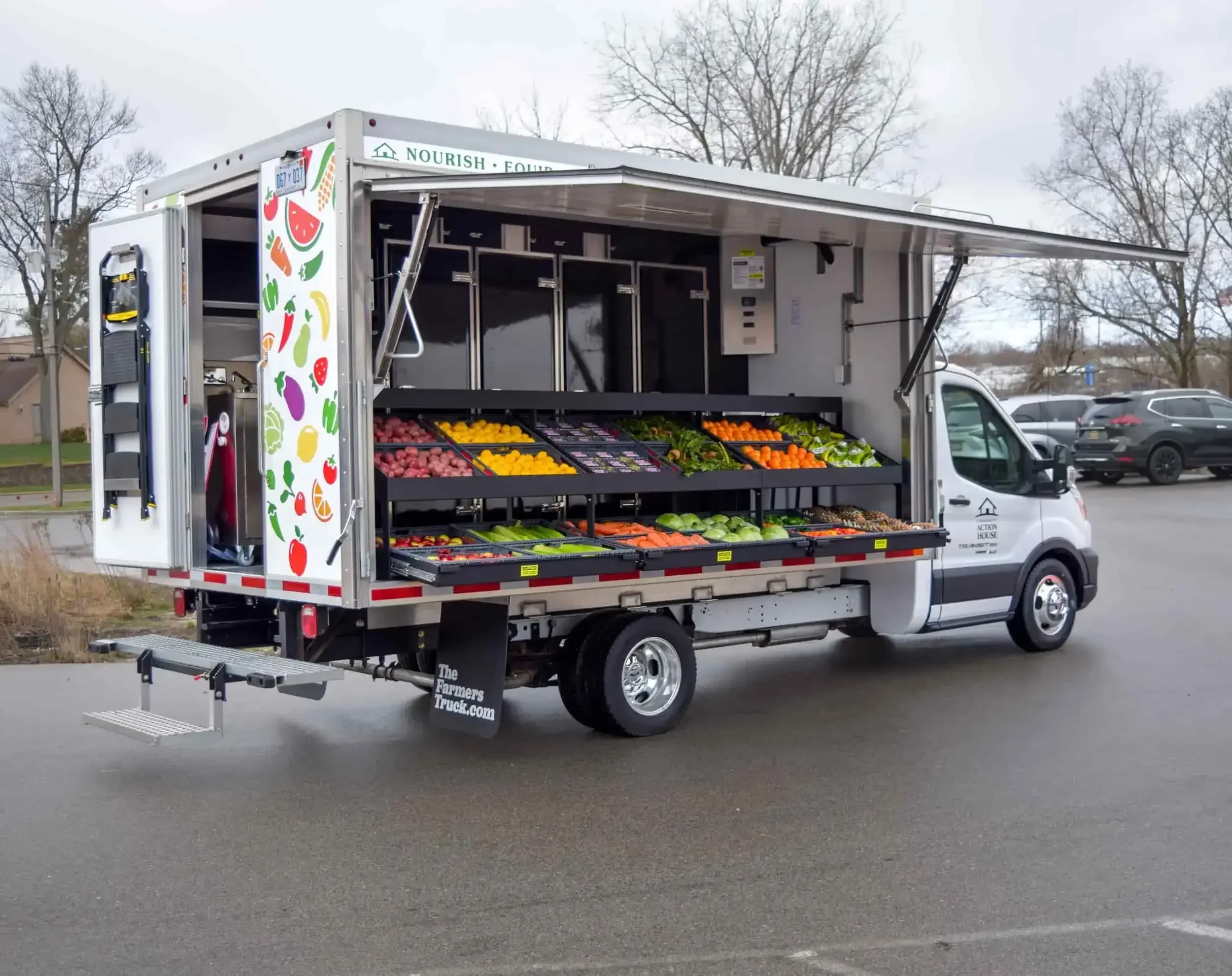 A mobile market truck parked filled with produce