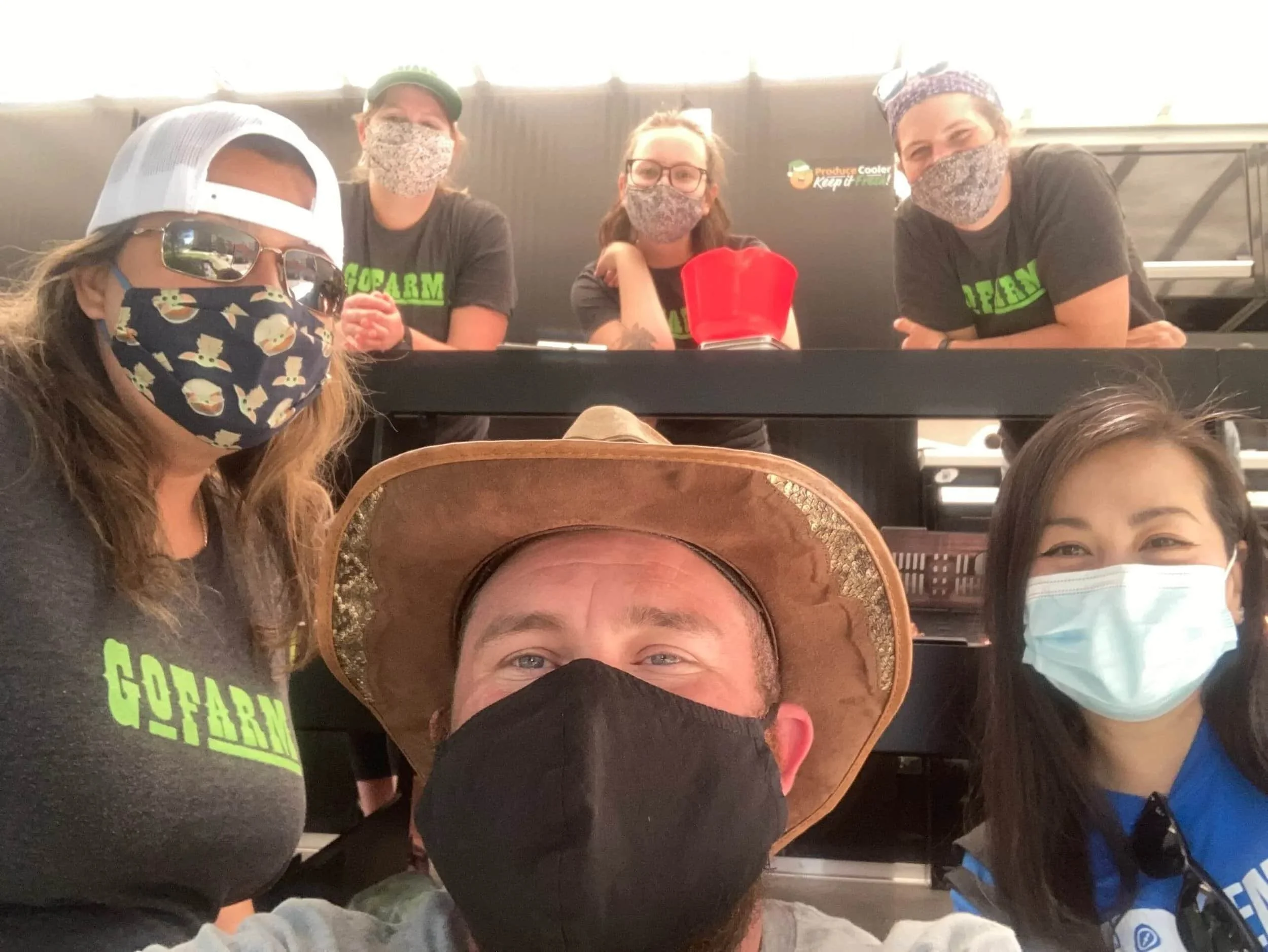 Doug Wooley posing with GoFarm employees at mobile market truck