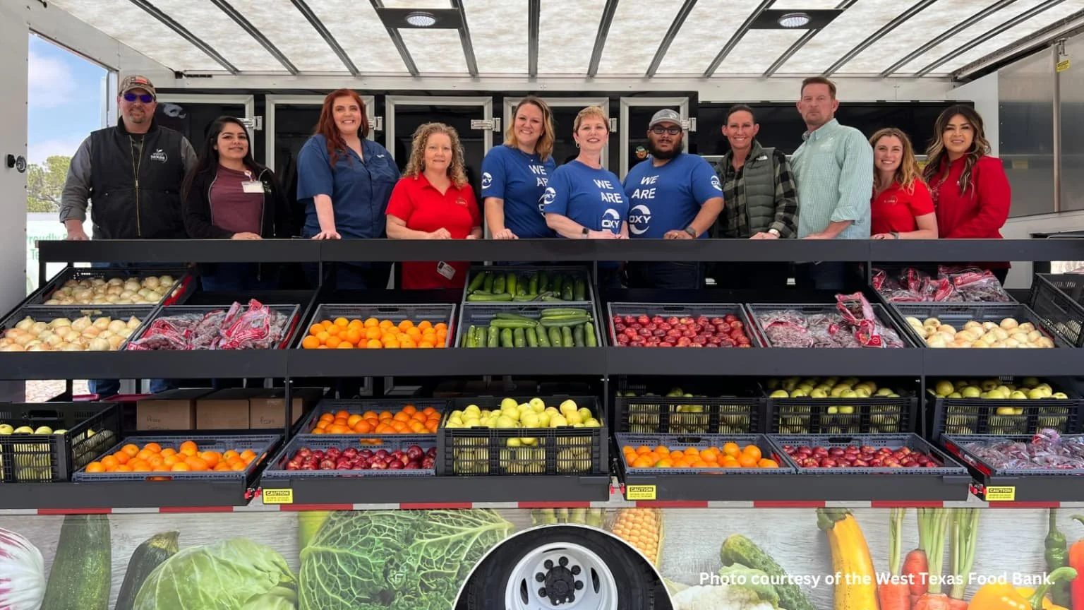 Volunteers posing on a mobile market truck