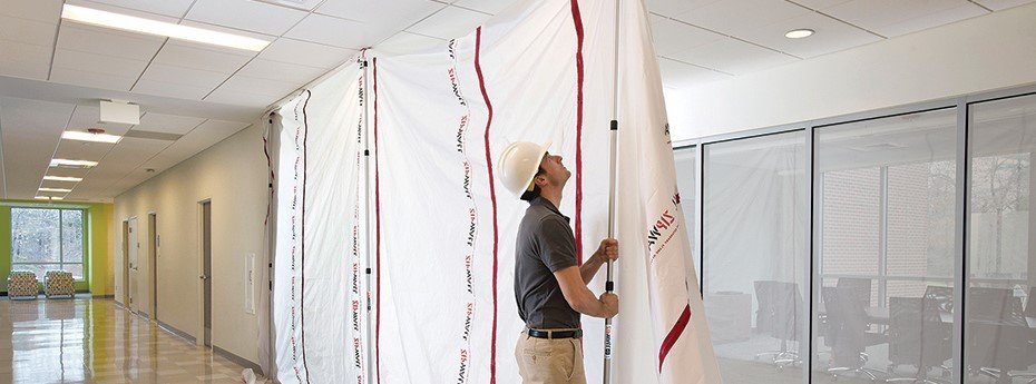 Professional dust containment barriers and HEPA filtration during NYC hallway renovation