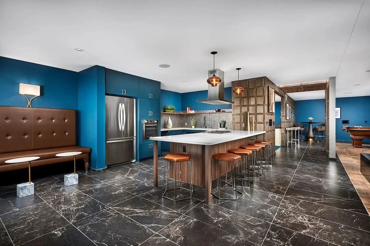 Common kitchen amenity space in NYC apartment building with modern appliances and residential-style finishes