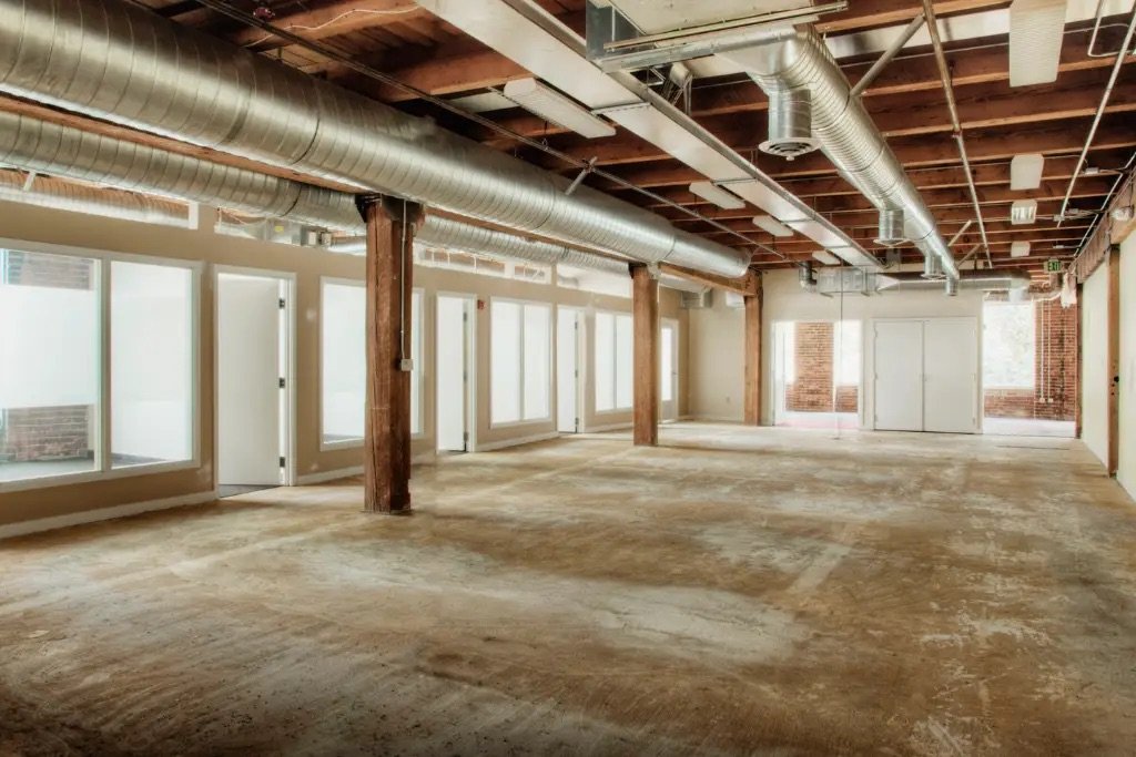 Commercial gut renovation construction site in NYC showing exposed structural framework and mechanical systems