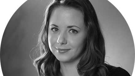 Black and white portrait of a woman with wavy hair, smiling softly. Kristen Welker, Teaching Assistant.