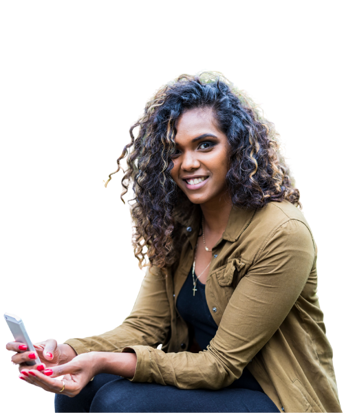 A smiling woman with curly hair holding a smartphone