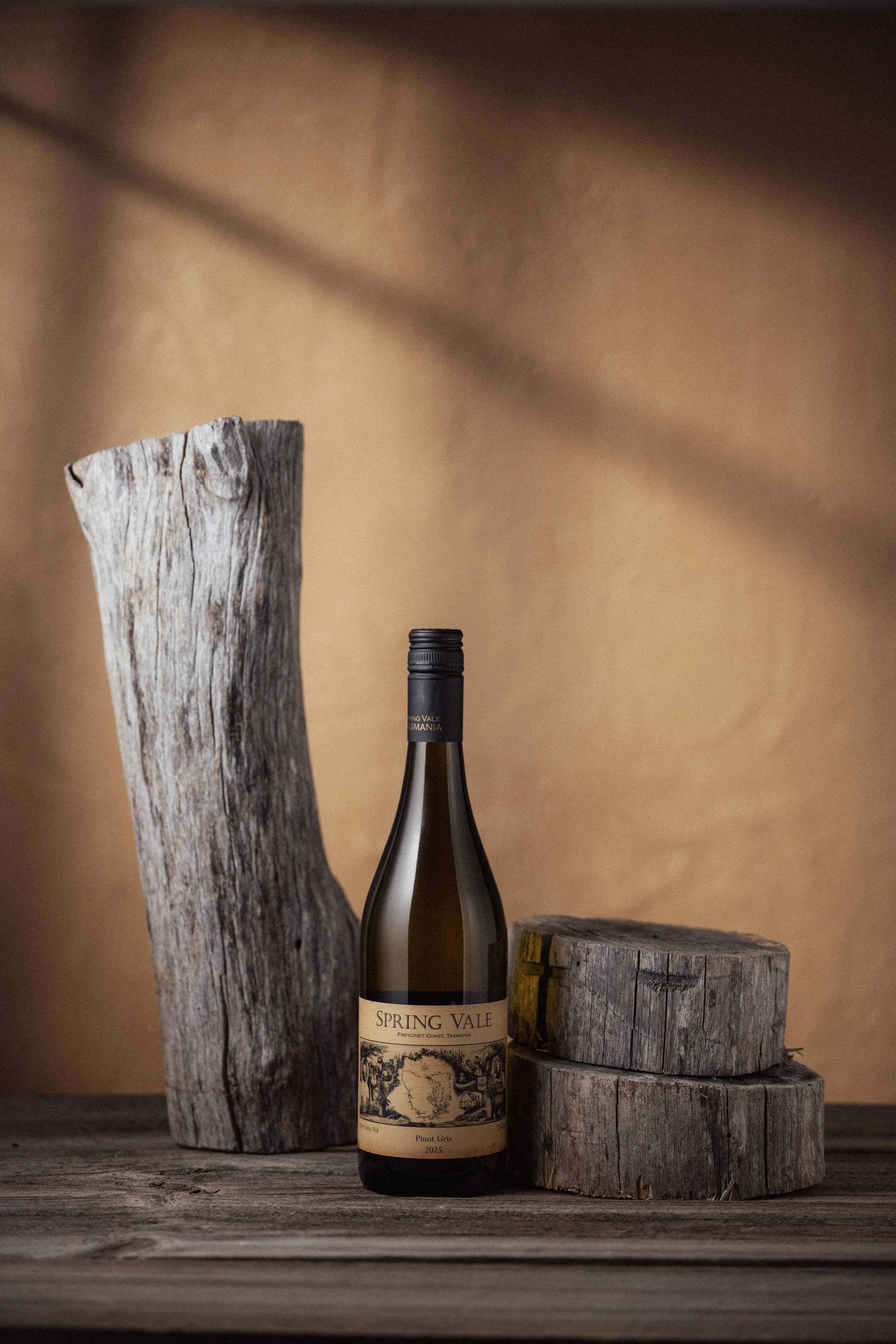 Multiple bottles of red wine in a wooden crate with straw padding, labels reading "Spiring Vale" and "Pinot Noir" from 2009.