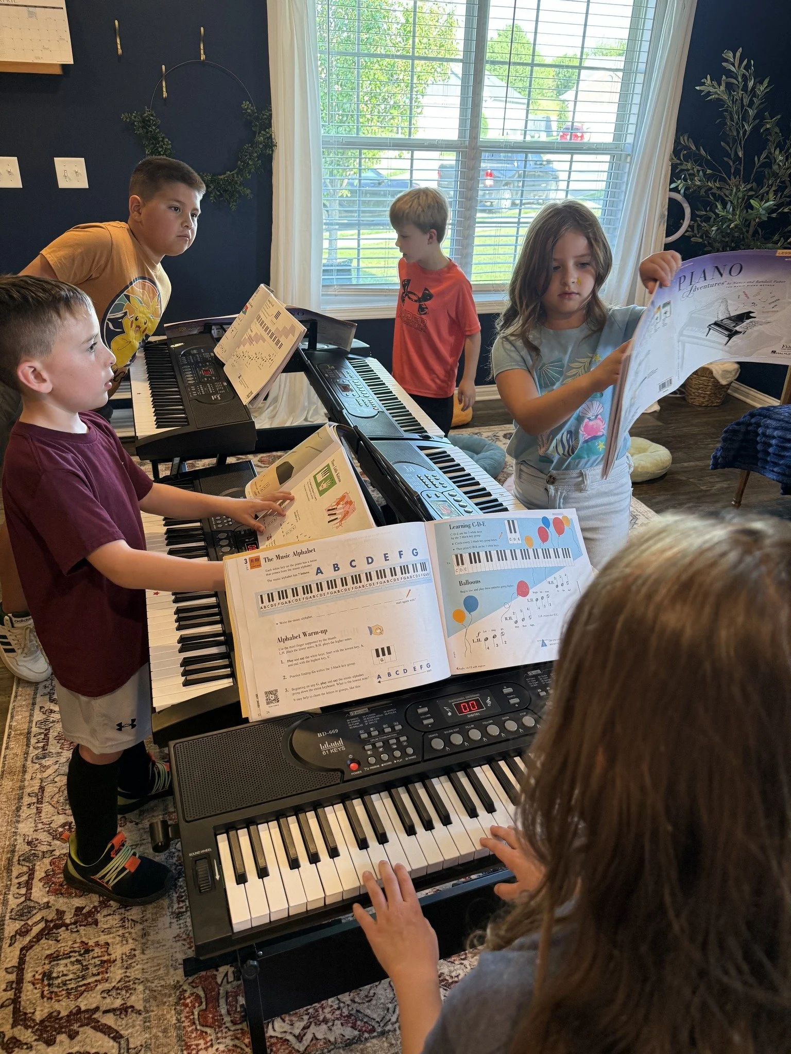 3 students standing behind pianos during a group class