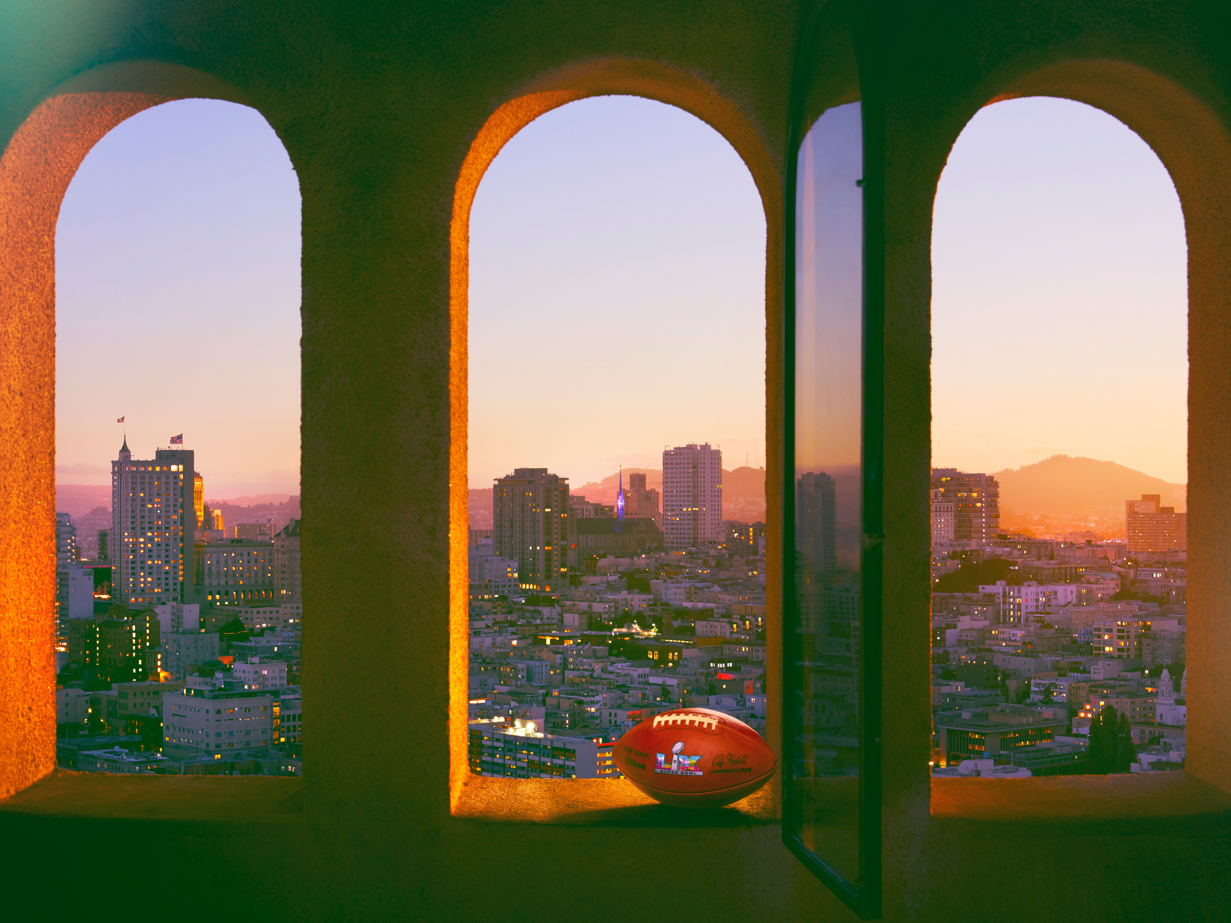 Super Bowl LX football in arched window overlooking San Francisc