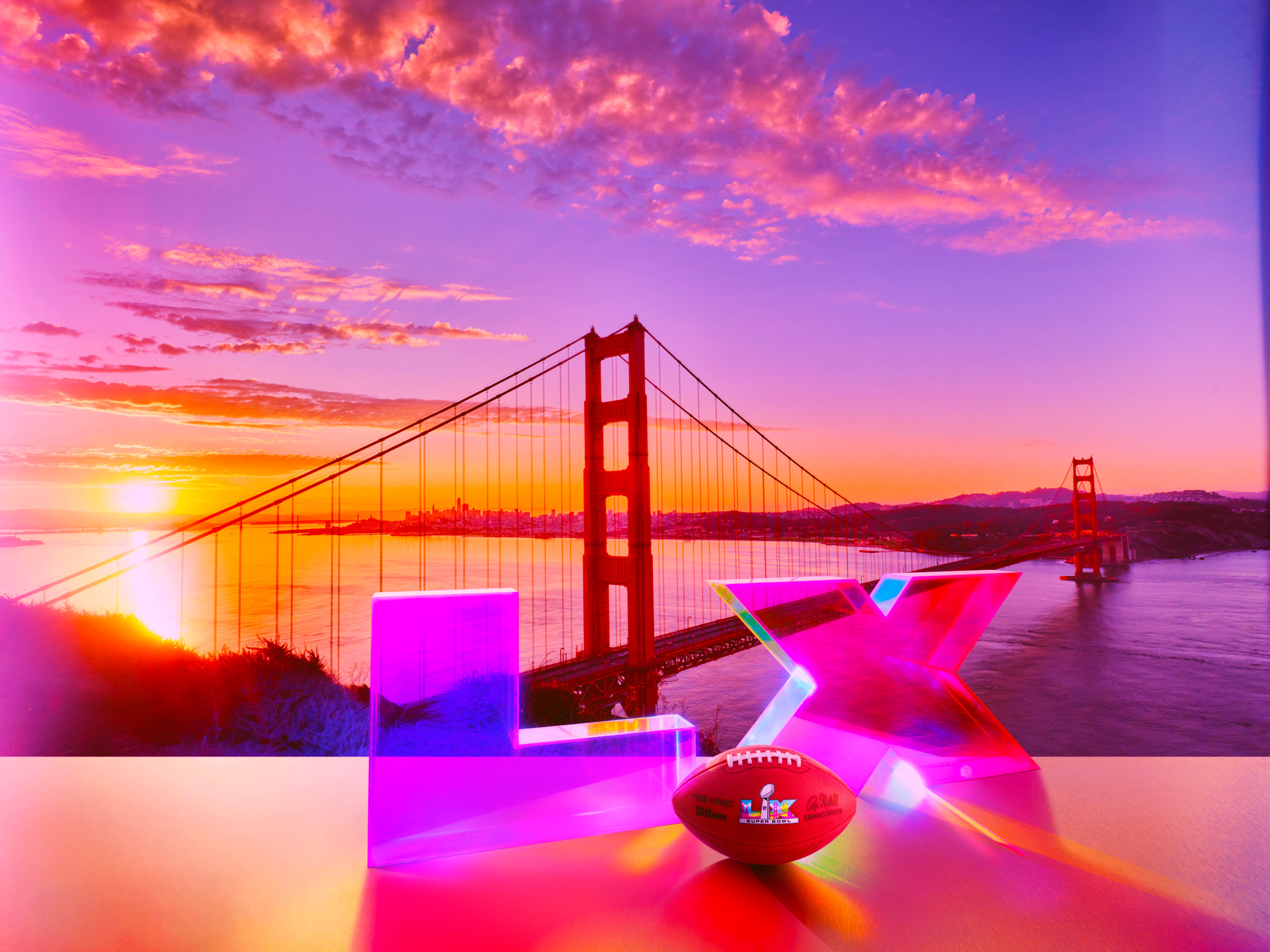 Super Bowl LX logo transparent render in front of Golden Gate bridge