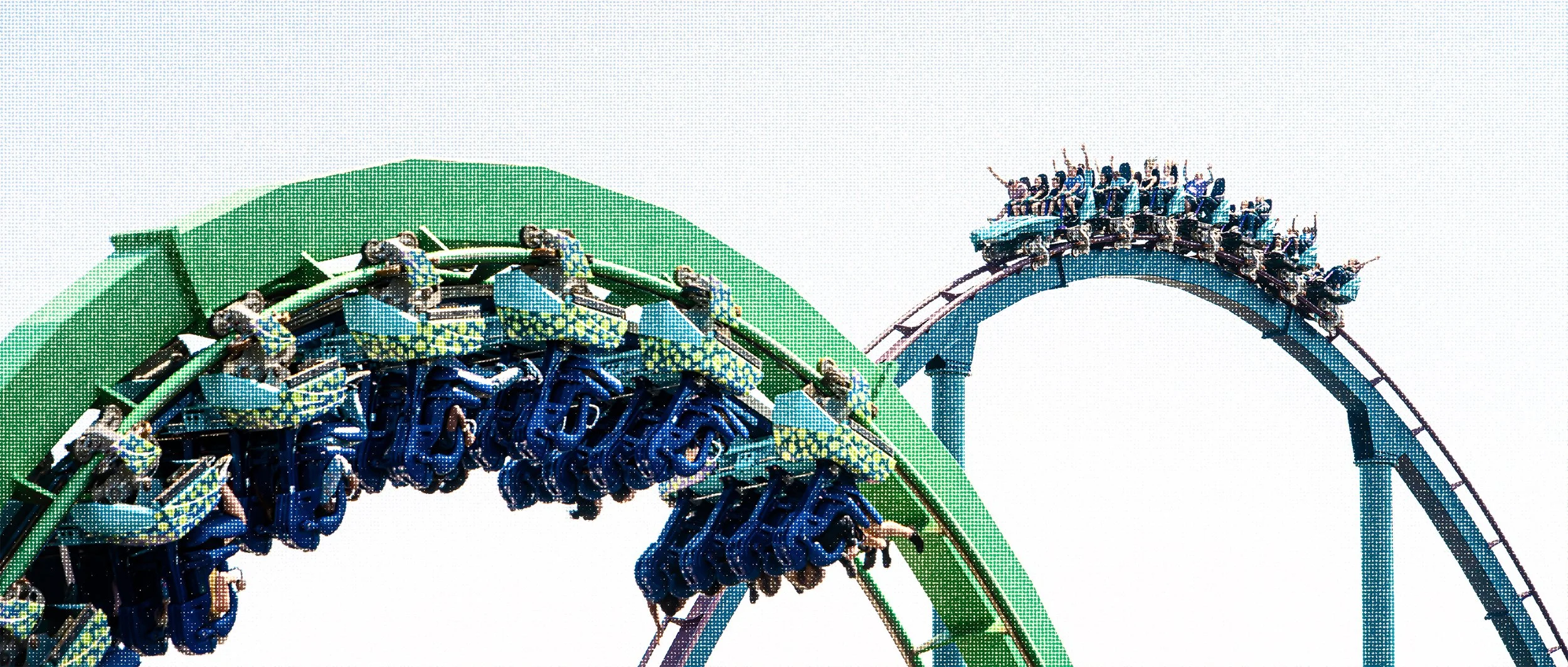 Two roller coasters at SeaWorld Orlando crossing over each other in the same frame.