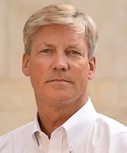 Professional headshot of Vice Admiral Robert Thomas, USN Retired.