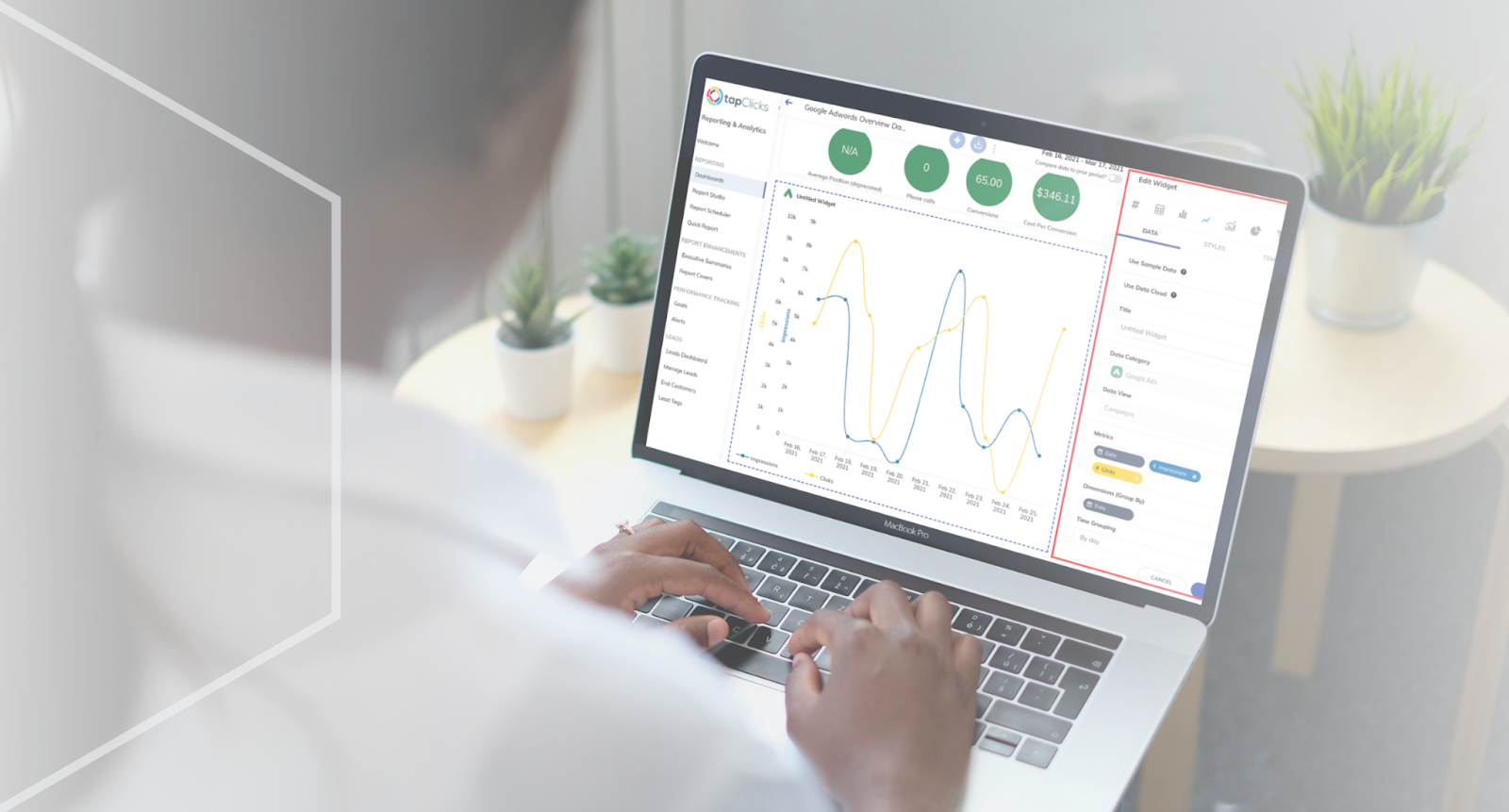Person analyzing data on a MacBook Pro with graphs and charts on screen in a bright office with potted plants in the background.