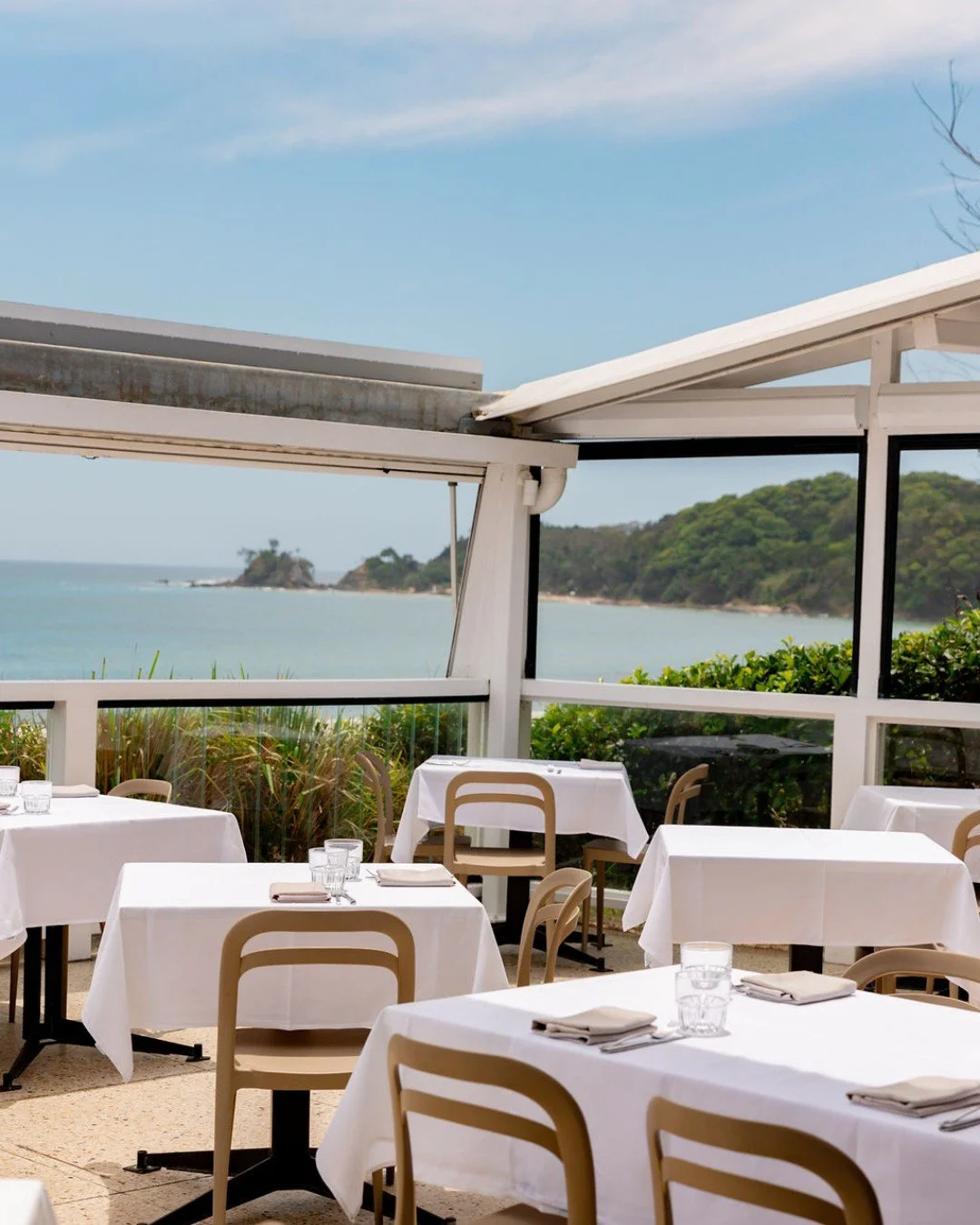 Sunlit tables, sea breeze drifting through, and the sound of the shoreline just steps away.

Book your spot by the water.