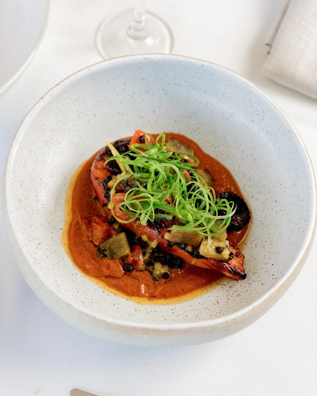 Barbecued octopus with nduja cream, roasted peppers and spring onion.
Charred, tender and well balanced on the plate.