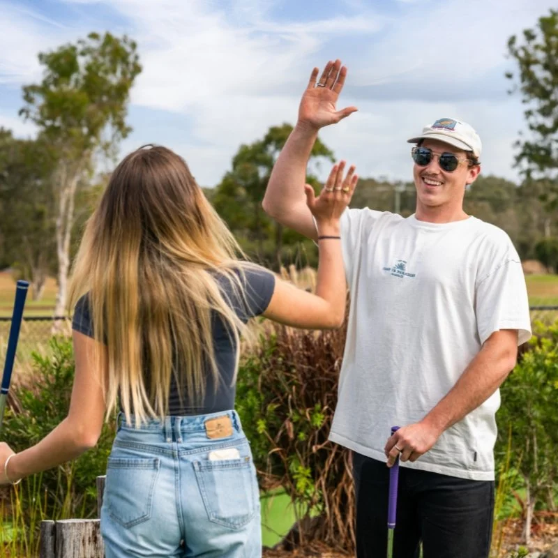 high fiving couple at mini golf