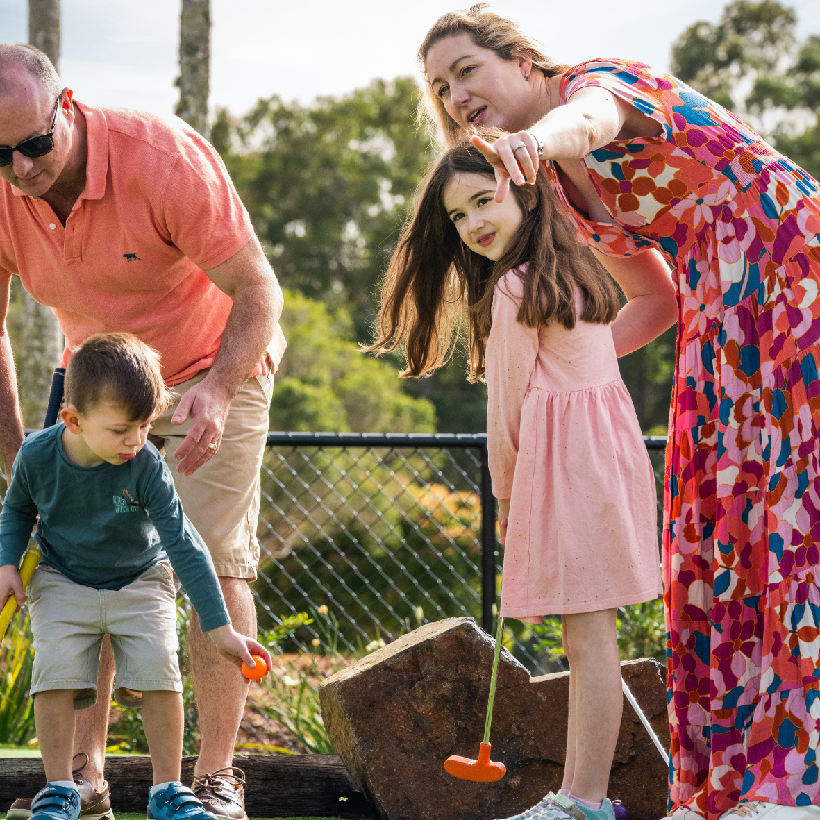 family playing putt putt at noosa mini golf