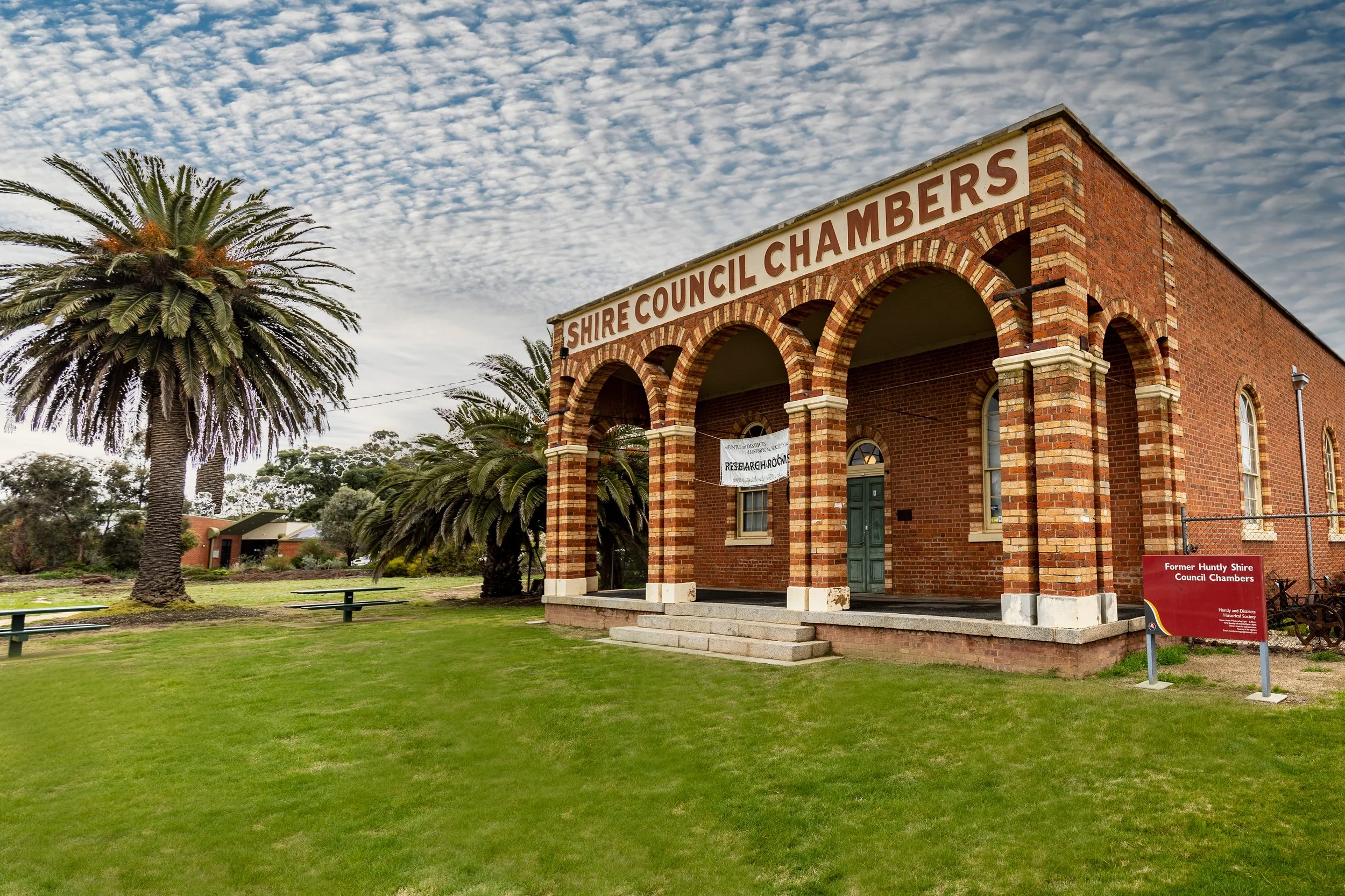 Red brick building with arched entrance labeled 
