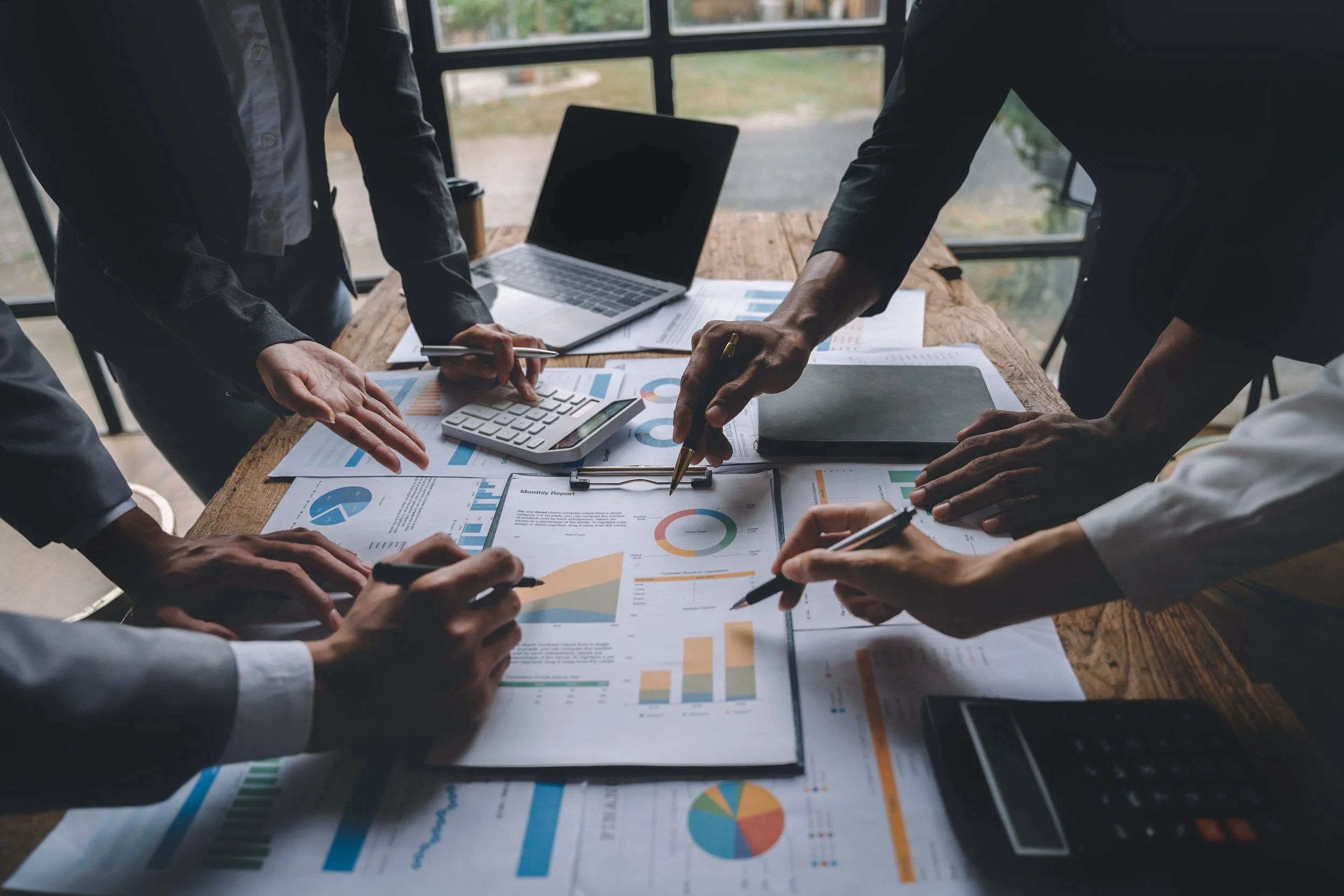 Executives discussing The Gestaldt Accountability Framework™ infographic showing six pillars of organisational accountability from clarity to performance.