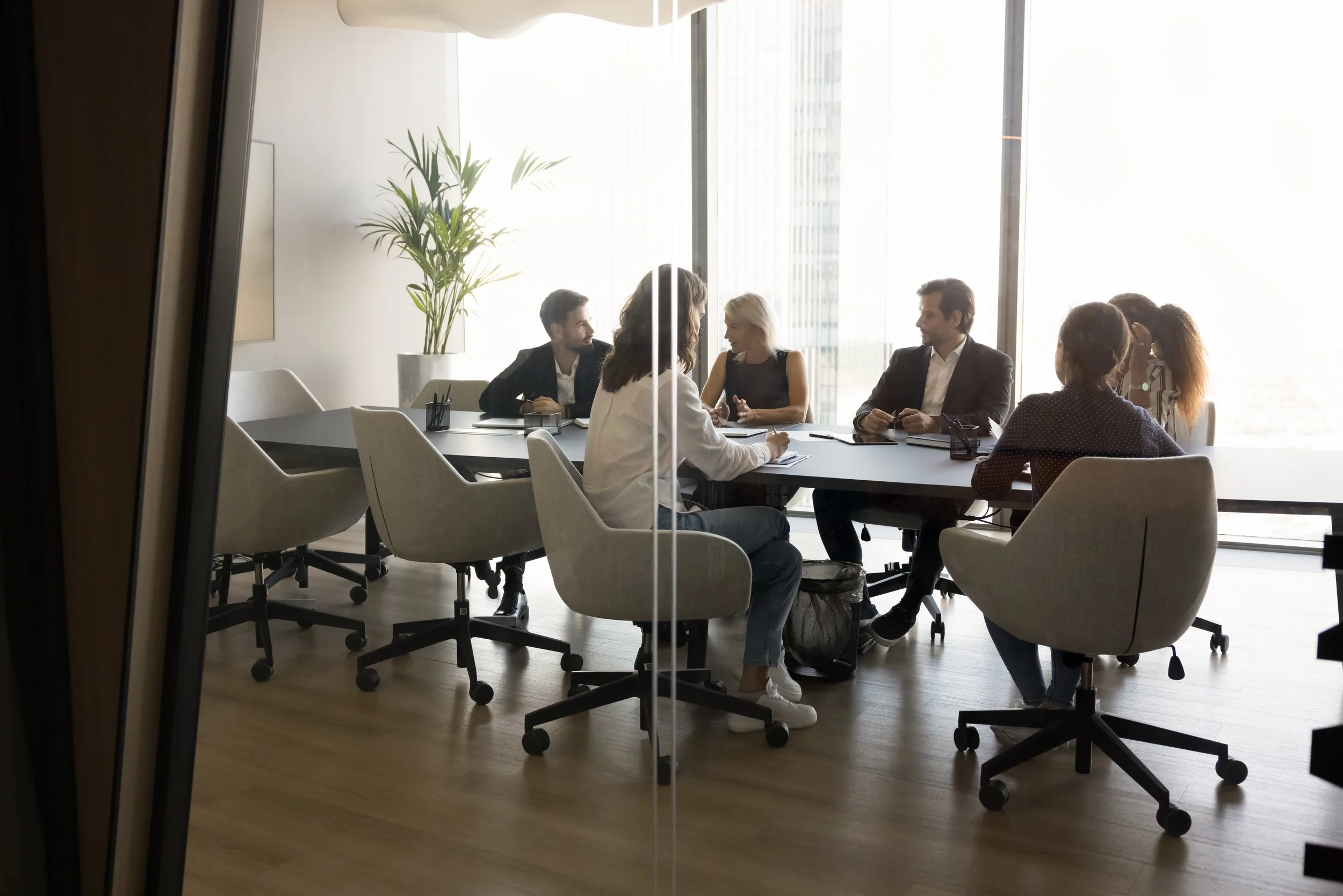 A diverse executive leadership team reviewing strategic performance dashboards in a modern boardroom by Gestaldt