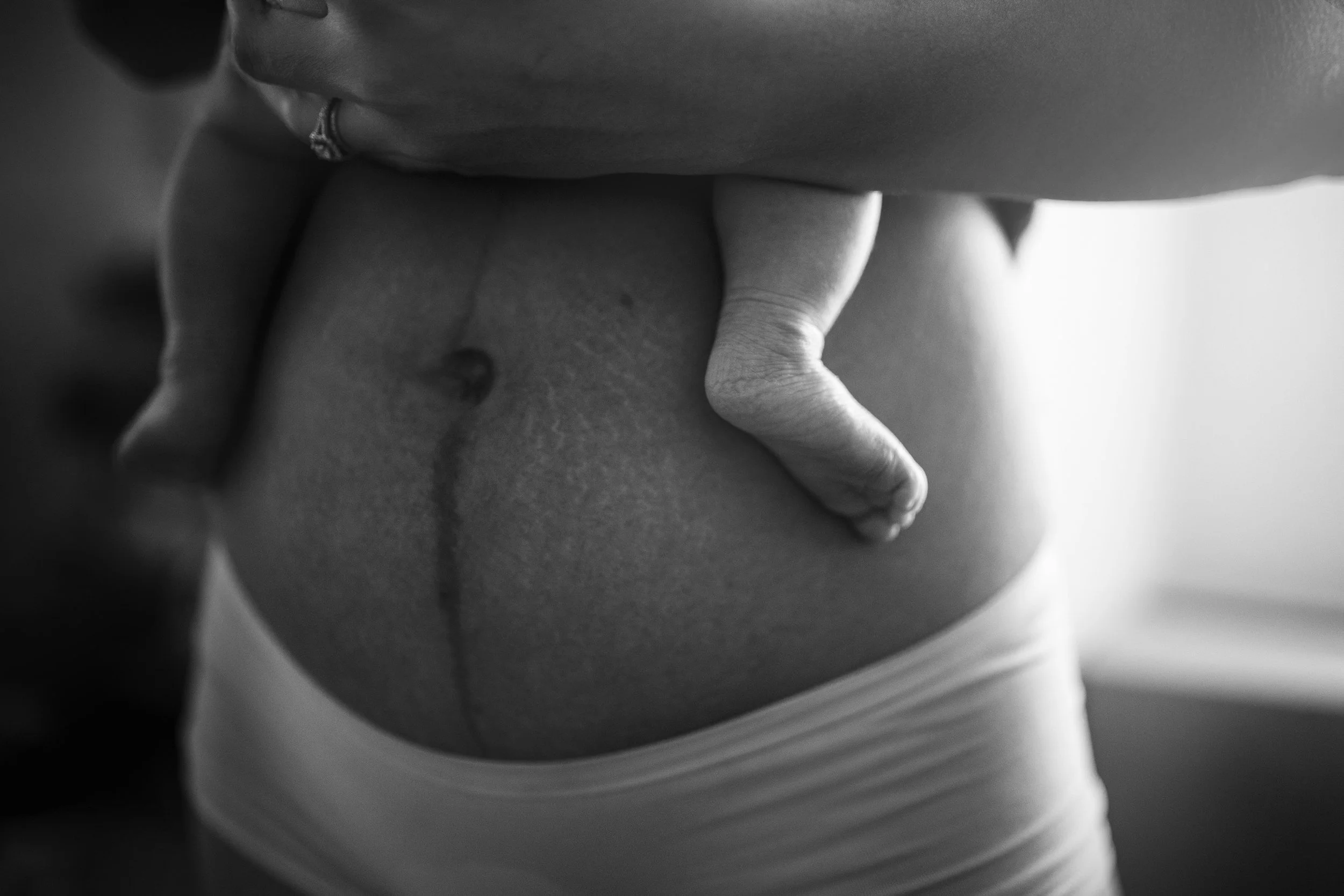 Postpartum body, mom holding her baby