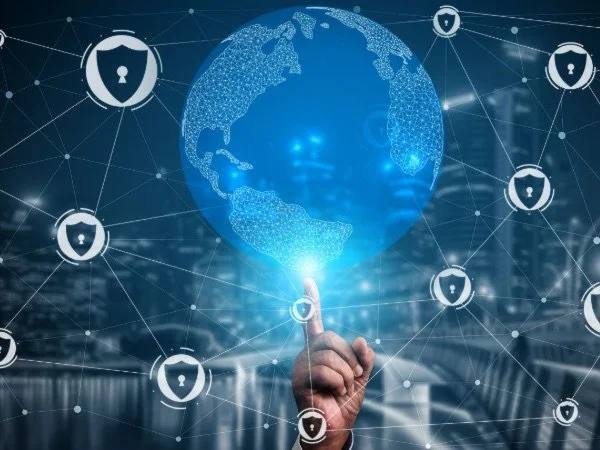 A hand touching a digital globe of Earth with interconnected security shield icons circling around it.
