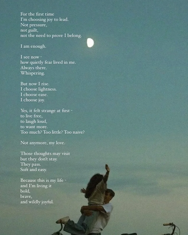 A person lifting another person into the air outdoors during twilight, with a bicycle nearby, under a sky with a visible moon and poetic text overlay.